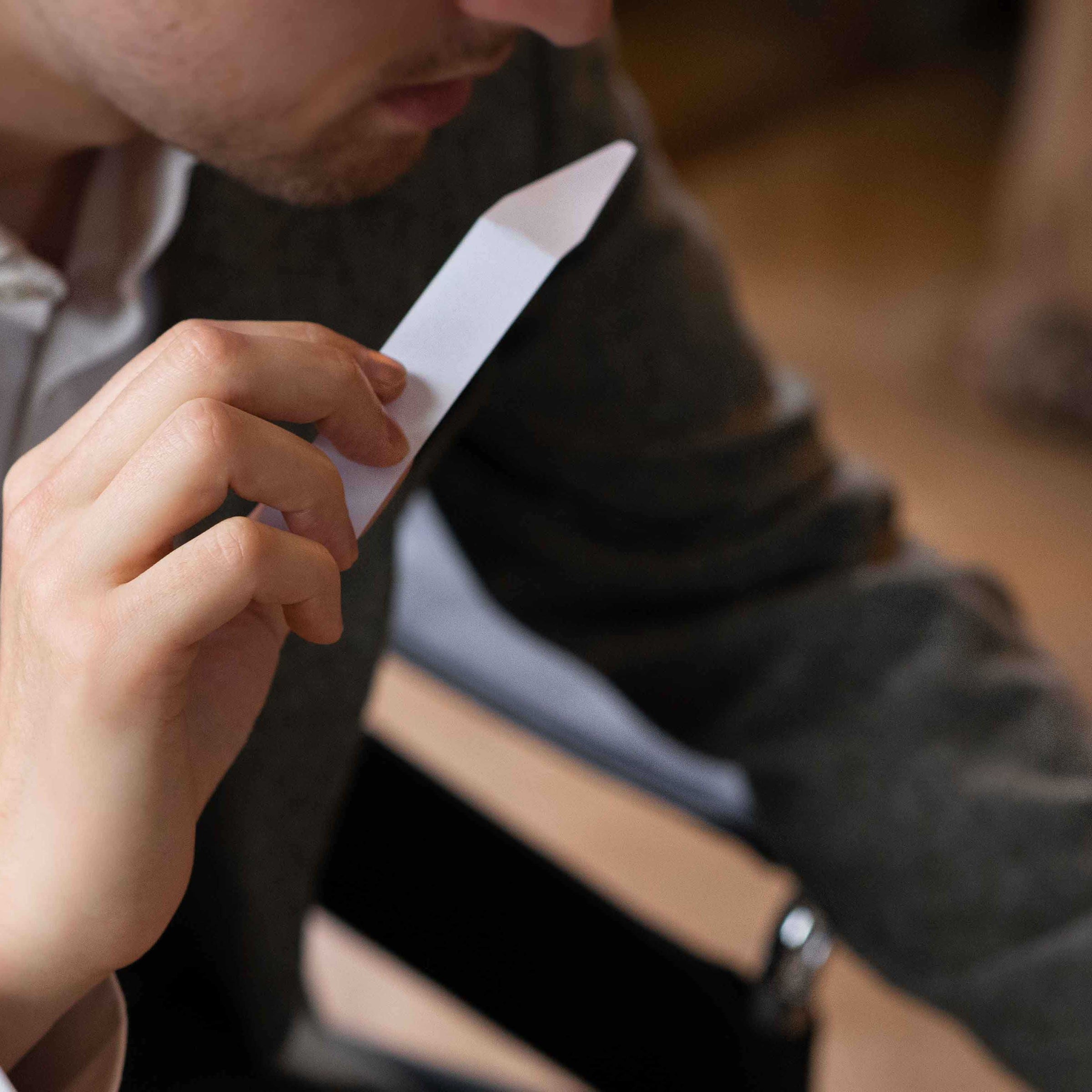 Fiole specialist samples fragrances on a blotter.