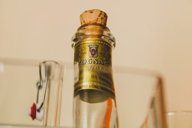 Cognac bottle with cork stopper.